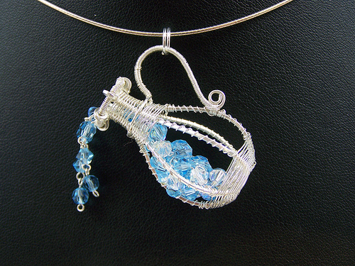 wire jug pouring blue beads